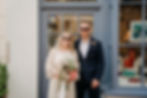stylish bride and groom standing in a blue doorway in the lanes in brighton after their wedding