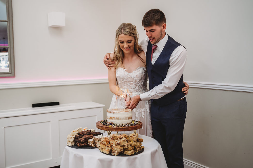bride and groom cutting the wedding cake at Cottesmore golf club, Cottesmore wedding