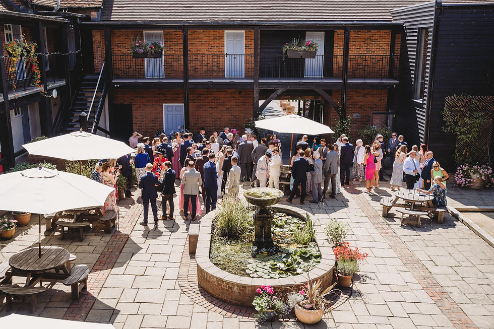wedding guests in the courtyard at Cottesmore golf club wedding