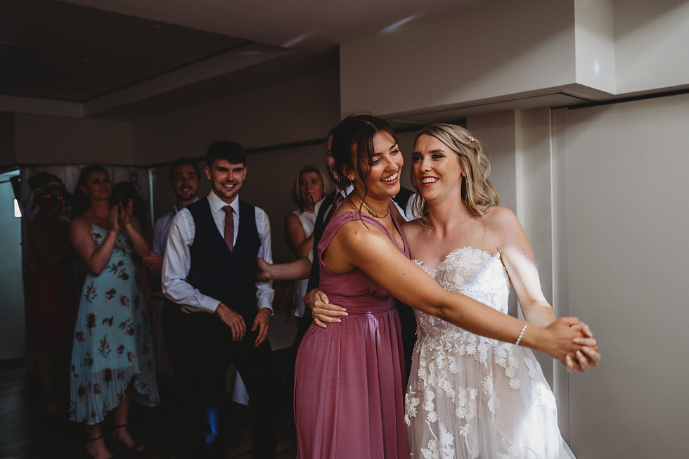 bride and bridesmaid dancing during evening reception at Cottesmore golf club wedding