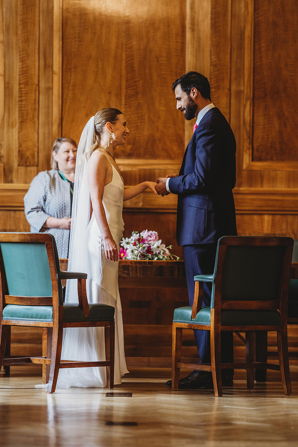 groom putting on the brides ring during wedding ceremony at hackney town hall