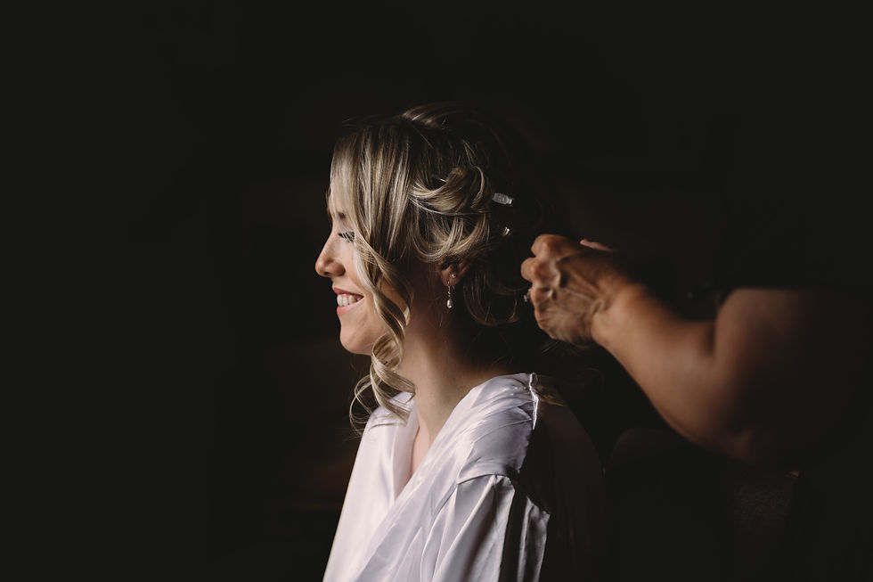 bride having her hair done the morning of her wedding at Cottesmore golf club in sussex, Cottesmore wedding