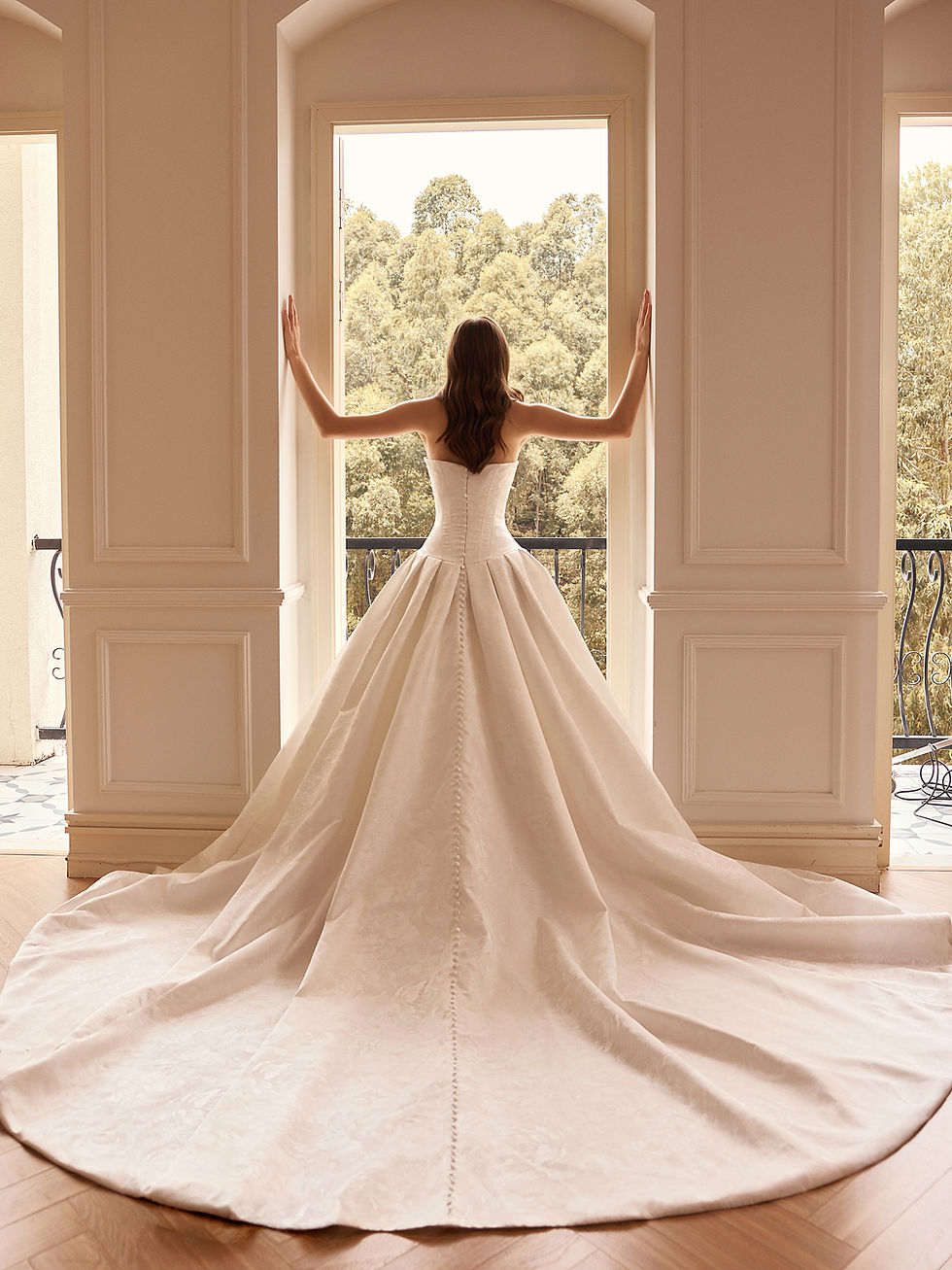 Jacquard bridal gown with pleated full skirt and cathedral train
