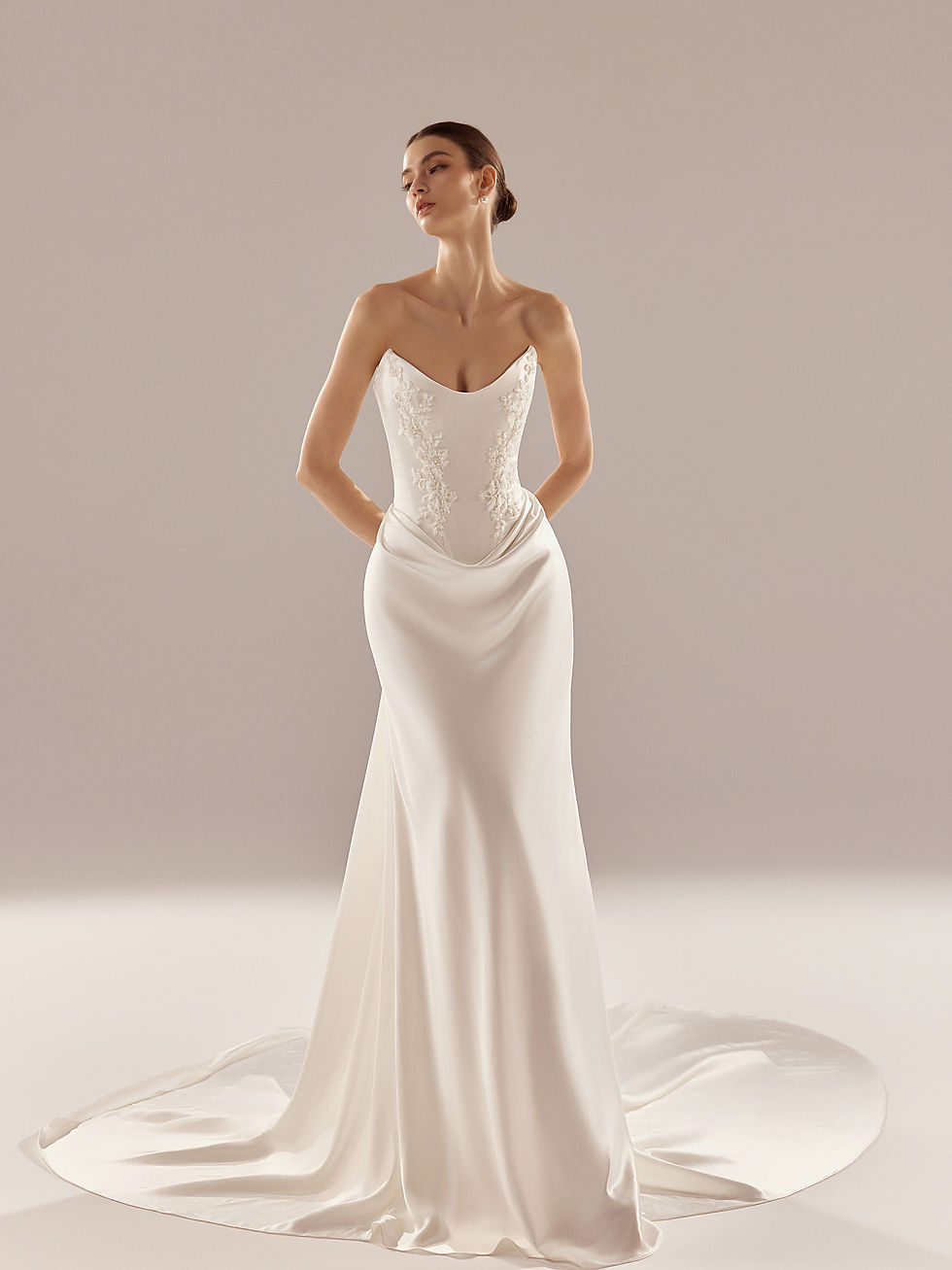 Satin wedding dress with sculpted strapless corset and beaded floral appliqués