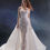 Thumbnail: Strapless floral lace bridal gown with sheer fitted silhouette and detachable overskirt.