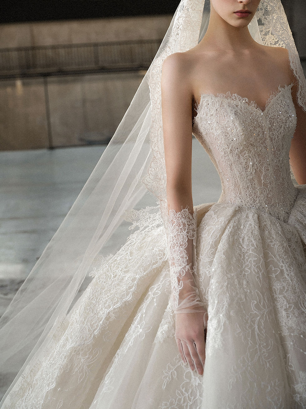 Strapless lace bridal gown with sweetheart neckline and voluminous ball skirt.