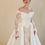 Thumbnail: Off-the-shoulder corset bridal gown with lace sleeves and satin overskirt.