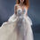 Thumbnail: Bridal gown with sheer corset bodice, 3D floral appliqués, puff sleeves, and flowing tulle A-line skirt.