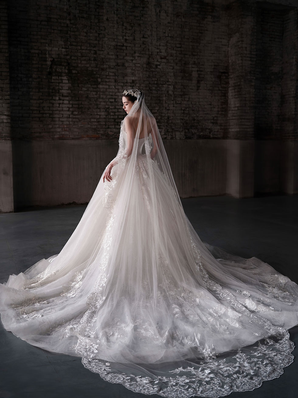 Thumbnail: Satin and lace bridal gown with folded neckline and floral appliqué skirt.