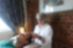 A complementary therapist in Hertfordshire/Essex performs a relaxing head massage on a male client l