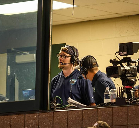 Liam Statz broadcasting a night game of baseball.