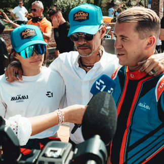 Overhead view of an E1 Team Miami pilot waving from the cockpit of the team’s electric race boat.