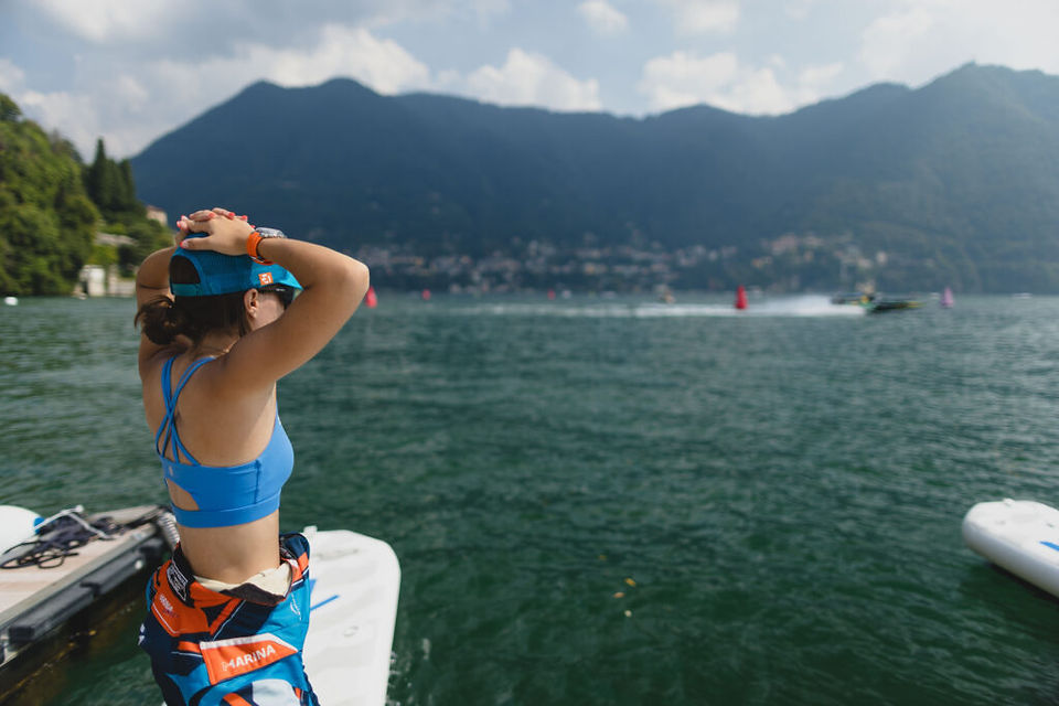 Team Miami pilot Anna Glennon watches the RaceBirds compete across Lake Como surrounded by scenic Italian mountains.