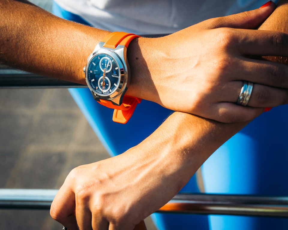 Close-up of a Bulova Marine Star B watch with an orange strap worn by a Team Miami member.