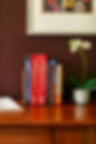 Books and a flower on the desk in my treatment room.