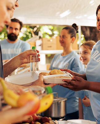 outdoor-food-drive-event-with-volunteers-different-ethnicities-serving-homeless-individual