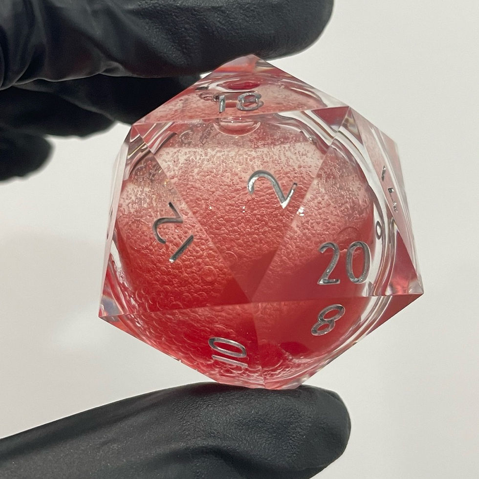 Black gloved hand holds clear red liquid core d20 chonk showing numbers 2, 12, 20.