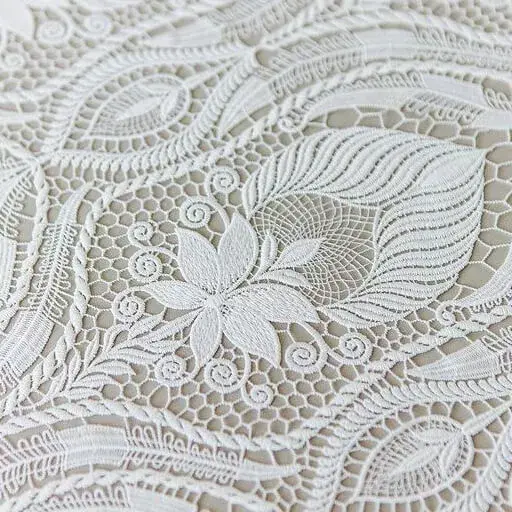 Delicate lace curtains in a charming living room, adding a soft, vintage touch with intricate patterns and allowing natural light to filter through, creating a bright and airy atmosphere