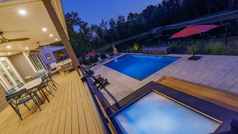 a large swimming pool is lit up at night