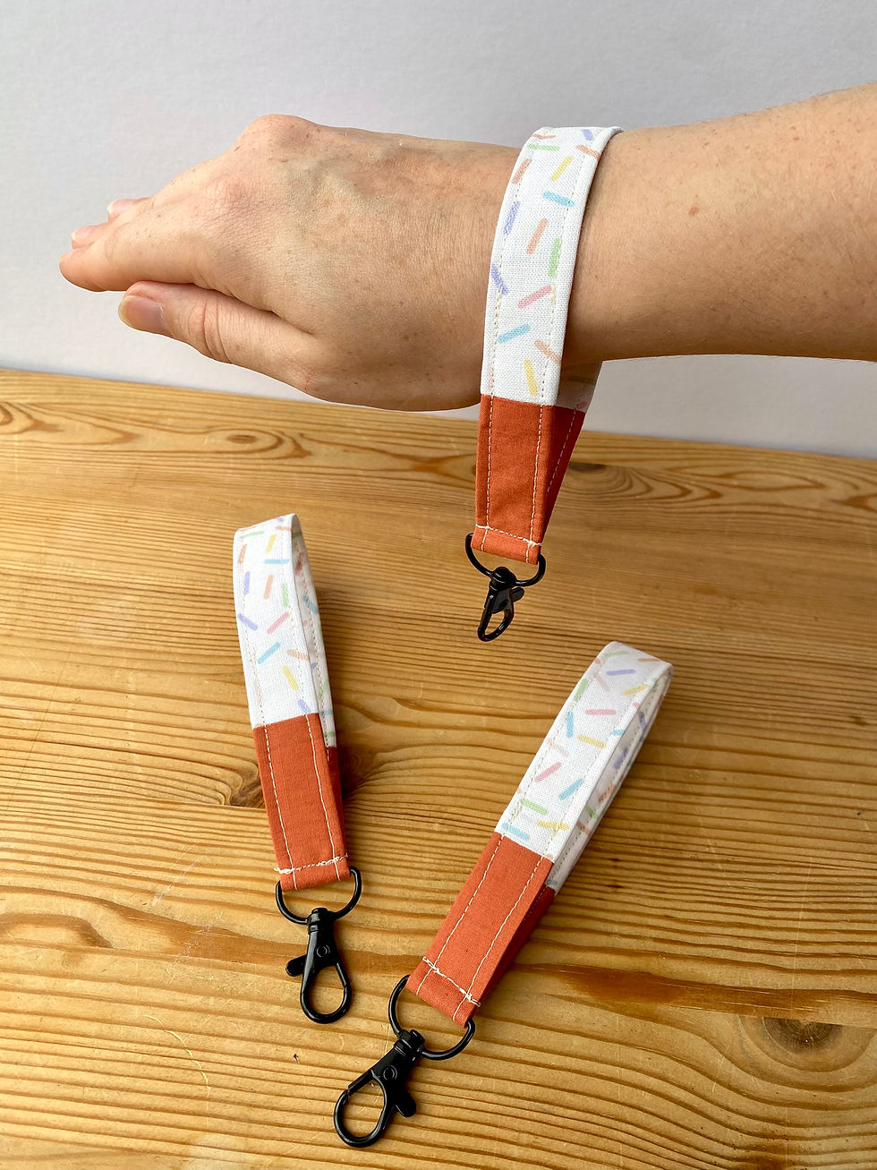 Thumbnail: Showing cake sprinkles wristlet on wrist