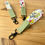 Thumbnail: Three summer meadow flower wristlets on table. close up details of flower fabric pattern