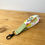 Thumbnail: Individual summer meadow flowers wristlet, white background fabric with bright minimalist flowers with contrasting green coot