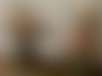 Floral posies standing against a white piece of furniture