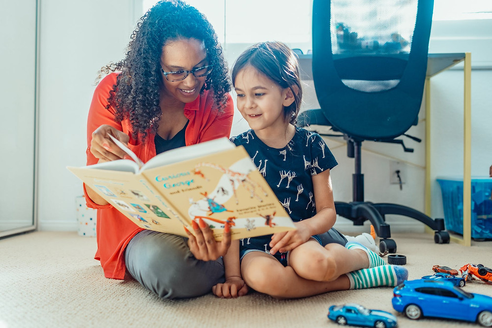 adoptive mother reading to her adopted child