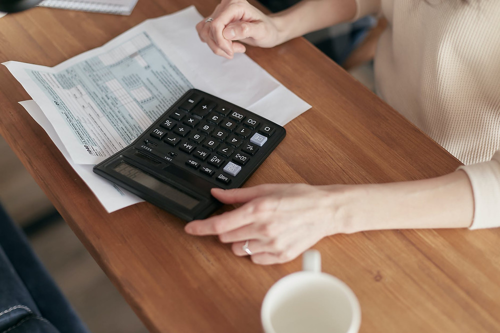 woman using calculator on taxes after divorce