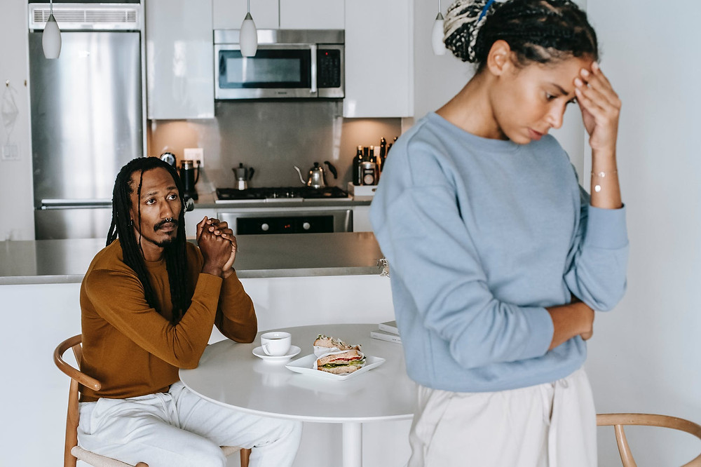 woman standing in kitchen asking husband for divorce