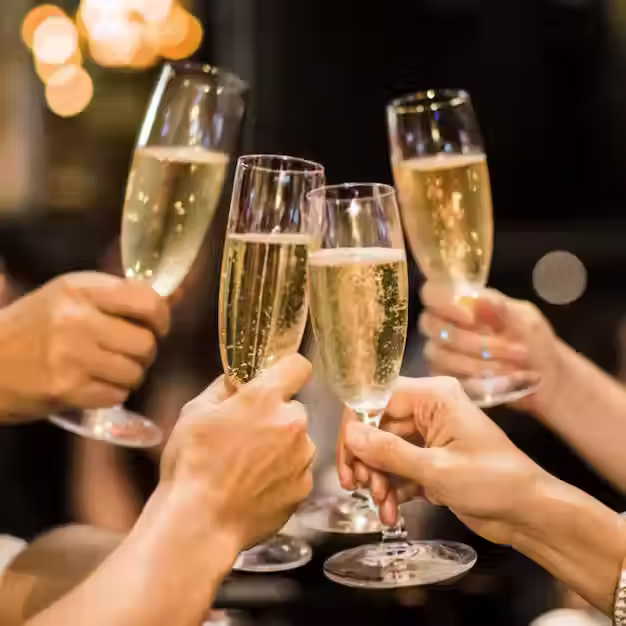 hand-holding-glass-champagne-people-cheering_618190-352.png