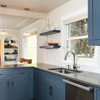 remodeled kitchen with tile backsplash, stainless steel appliances, and dusty blue cabinets