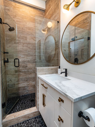 full tile shower with custom tile flooring in a luxury bathroom design