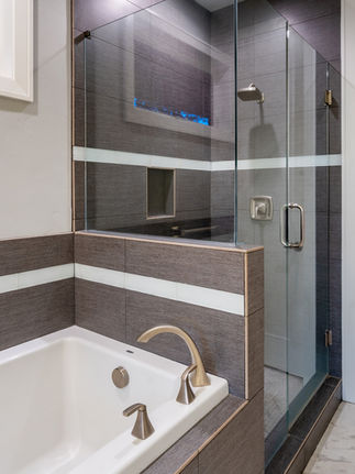 full tile shower with glass enclosure designed by PGC Building + Design