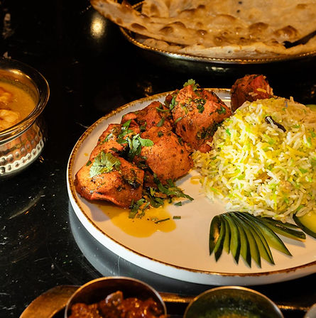 Grilled tandoori chicken with fragrant basmati rice served at an India Gate Indian restaurant in Lisbon.