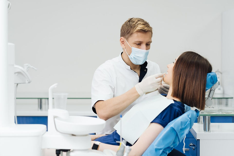 close-up-portrait-beautiful-young-lady-sitting-dental-chair-while-stomatologist-hands-ster