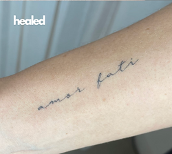 Gold Coast fine line cursive script tattoo on wrist