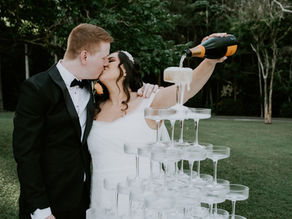Couple married in a lush private estate with luxurious champagne tower and pastel florals