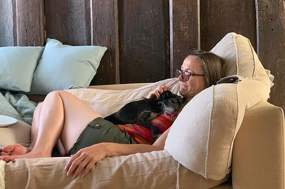 Sara Davies, the vet behaviourist, and Rita the dog, relax and watch TV