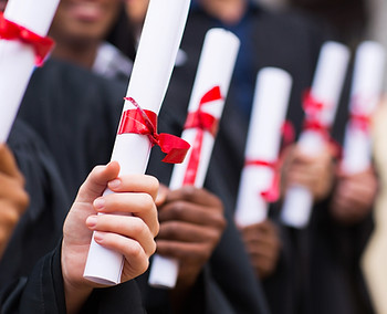 Graduates Holding Diplomas