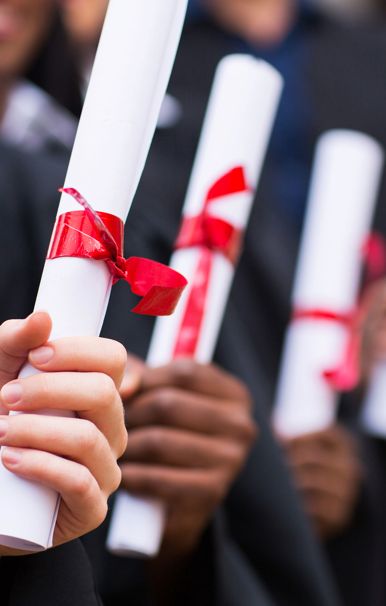 Graduates Holding Diplomas