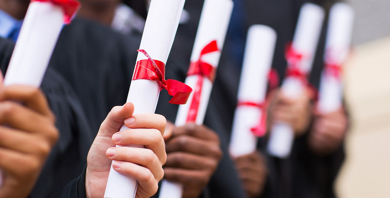Graduates Holding Diplomas