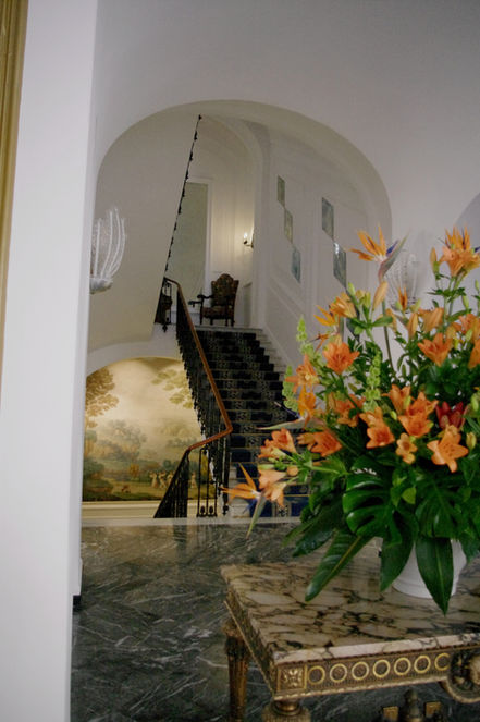 Luxurious hotel lobby of five star hotel Quisisana  in Capri with flowers and green marmor floors