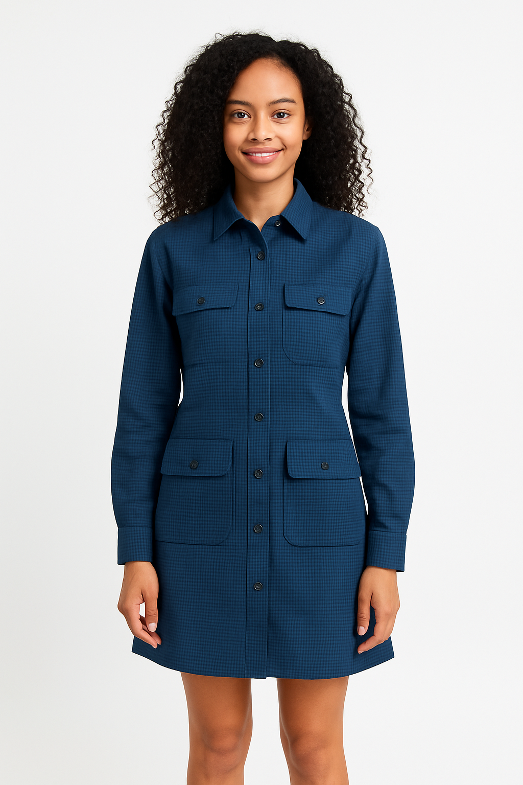 Smiling young woman in dark blue long-sleeved shirt dress with pockets.