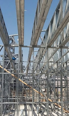 Metal framework of a building under construction, clear sky.