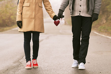 Couple holding paper hearts