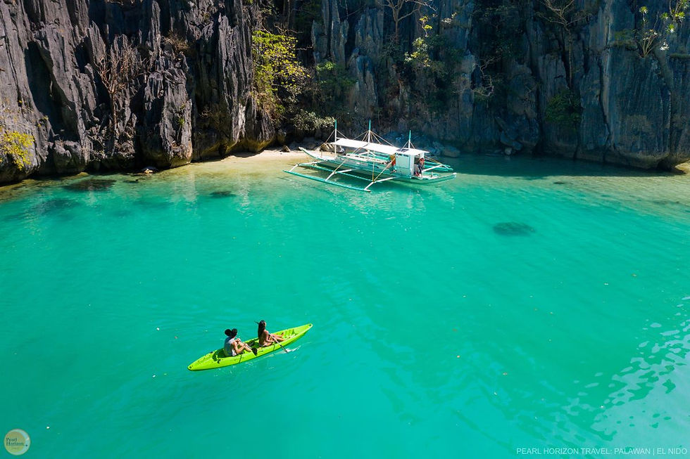 High angle view of a traditional Filipino boat sailing near limestone cliffs
