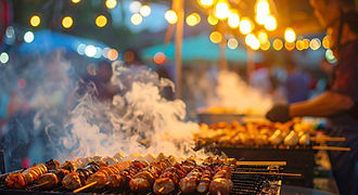 Steaming hot grilled skewers at the famous Carbon Night Market in Cebu City, surrounded by festive warm lights and the bustling atmosphere of an authentic food tour."