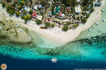 Marvel at this stunning aerial view of Pamilacan Island. Secure your Pamilacan island hopping tour package for a tropical getaway with Pearl Horizon Travel.