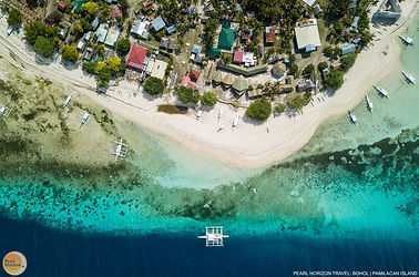 Marvel at this stunning aerial view of Pamilacan Island. Secure your Pamilacan island hopping tour package for a tropical getaway with Pearl Horizon Travel.